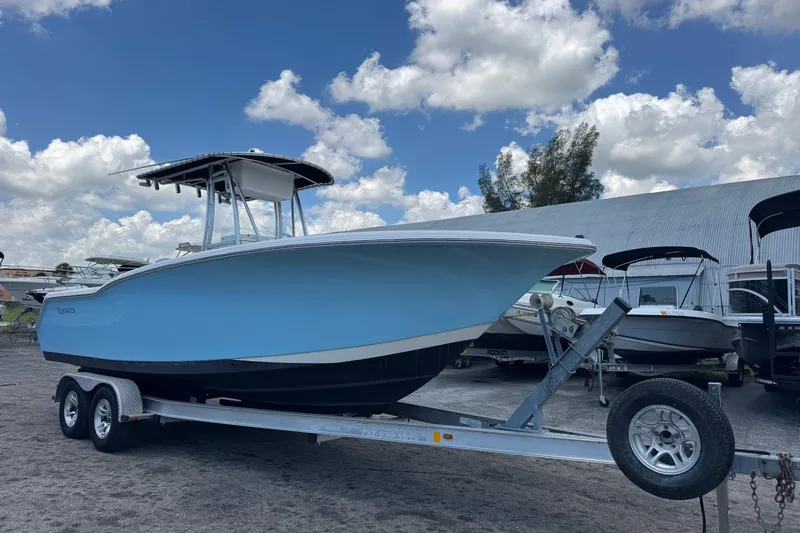 The Image of 2011 Tidewater 230 CC Adventure boat on trailer under blue sky. - 1