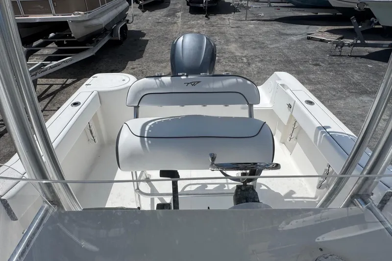 Slide: The Image of 2011 Tidewater 230 CC Adventure boat interior with seating and steering wheel. - 10