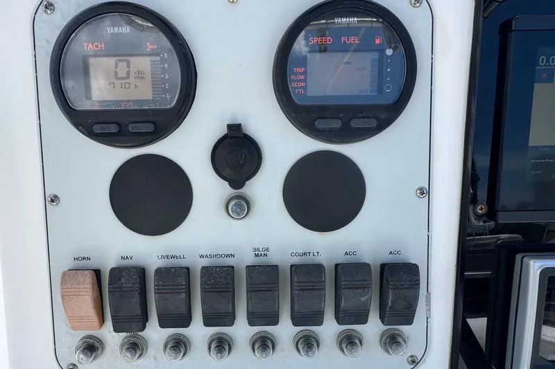 Slide: The Image of Control panel of a 2011 Tidewater 230 CC Adventure boat with gauges and switches. - 11
