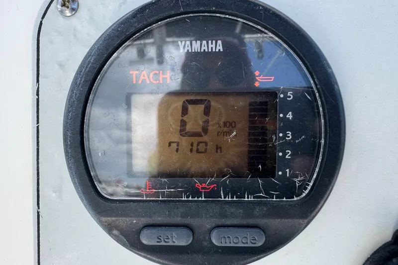 Slide: The Image of Yamaha tachometer displaying 710 hours on a 2011 Tidewater 230 CC Adventure boat. - 12