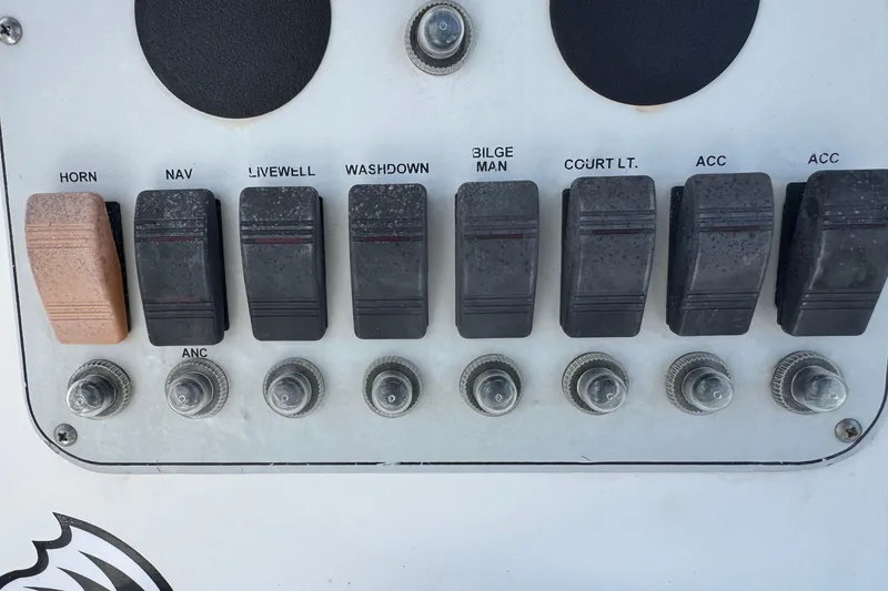 Slide: The Image of Control panel of a 2011 Tidewater 230 CC Adventure boat with labeled switches. - 14