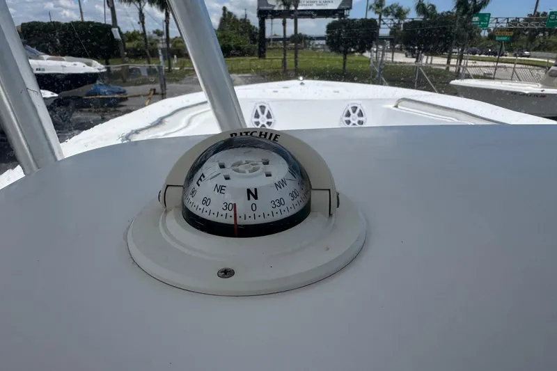 Slide: The Image of Compass on 2011 Tidewater 230 CC Adventure boat dashboard, outdoor setting. - 19