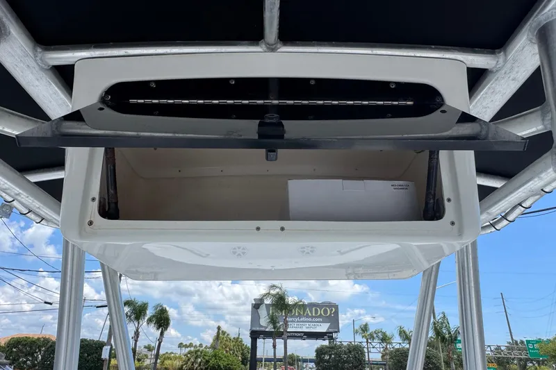 Slide: The Image of Open storage compartment on a 2011 Tidewater 230 CC Adventure boat, under a clear sky. - 20