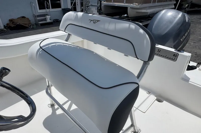 Slide: The Image of 2011 Tidewater 230 CC Adventure boat seat with Yamaha engine in background. - 21