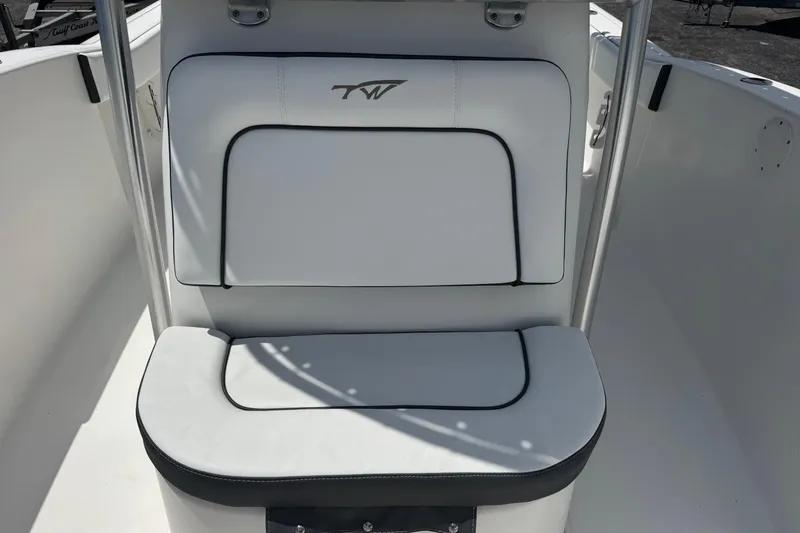 Slide: The Image of 2011 Tidewater 230 CC Adventure boat seat with white upholstery and black trim. - 24