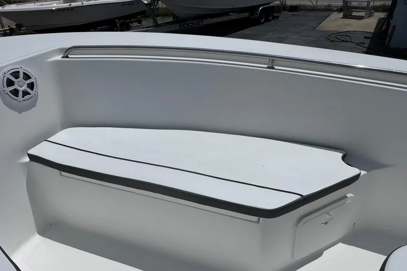 Slide: The Image of 2011 Tidewater 230 CC Adventure boat interior with cushioned seating and speaker. - 26