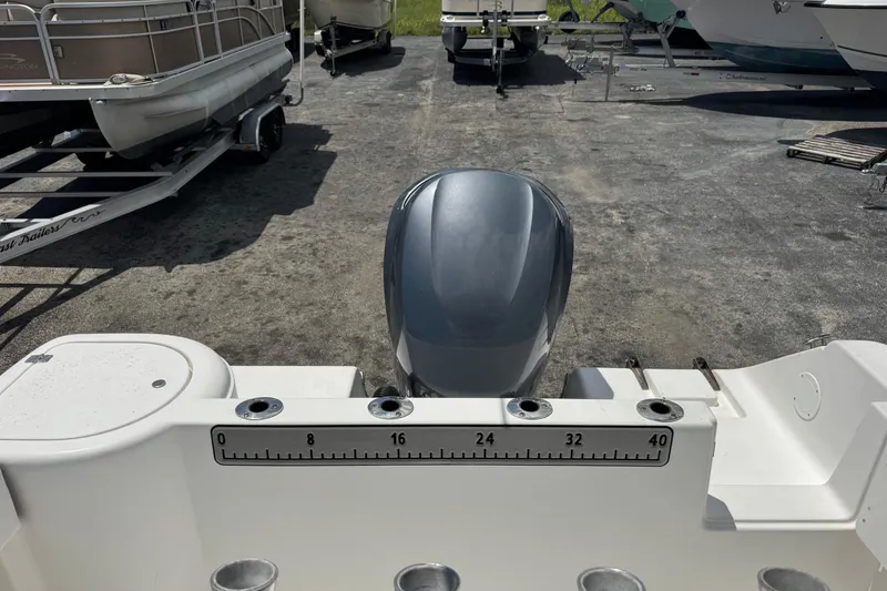 Slide: The Image of 2011 Tidewater 230 CC Adventure boat with outboard motor, docked on a trailer. - 31