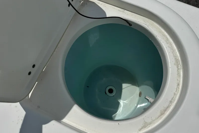 Slide: The Image of Open livewell on 2011 Tidewater 230 CC Adventure boat, showing interior details. - 32
