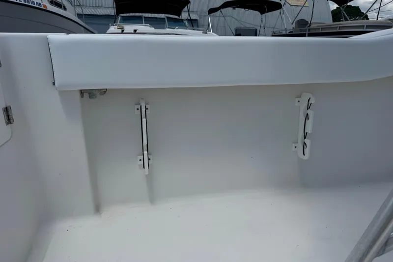 Slide: The Image of Interior view of a 2011 Tidewater 230 CC Adventure boat, showcasing seating and storage. - 36