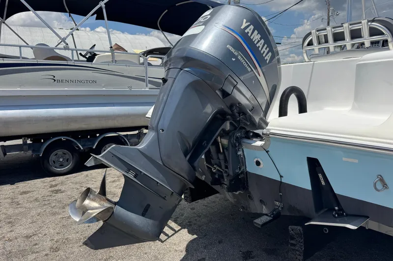 Slide: The Image of Yamaha outboard motor on 2011 Tidewater 230 CC Adventure boat, parked near Bennington pontoon. - 43