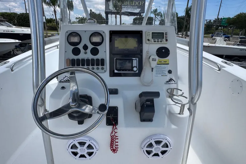 Slide: The Image of Center console of a 2011 Tidewater 230 CC Adventure boat with steering wheel and controls. - 6