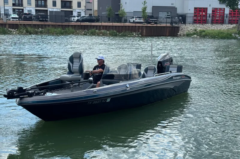 Slide: The Image of 2020 Ranger 2080MS Angler boat on water near urban buildings. - 10