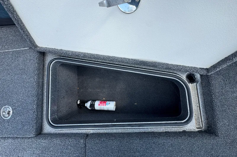 Slide: The Image of Storage compartment in a 2020 Ranger 2080MS Angler boat with a small bottle inside. - 16
