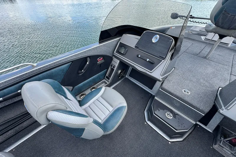 Slide: The Image of 2020 Ranger 2080MS Angler boat interior with seating and dashboard, on calm water. - 19