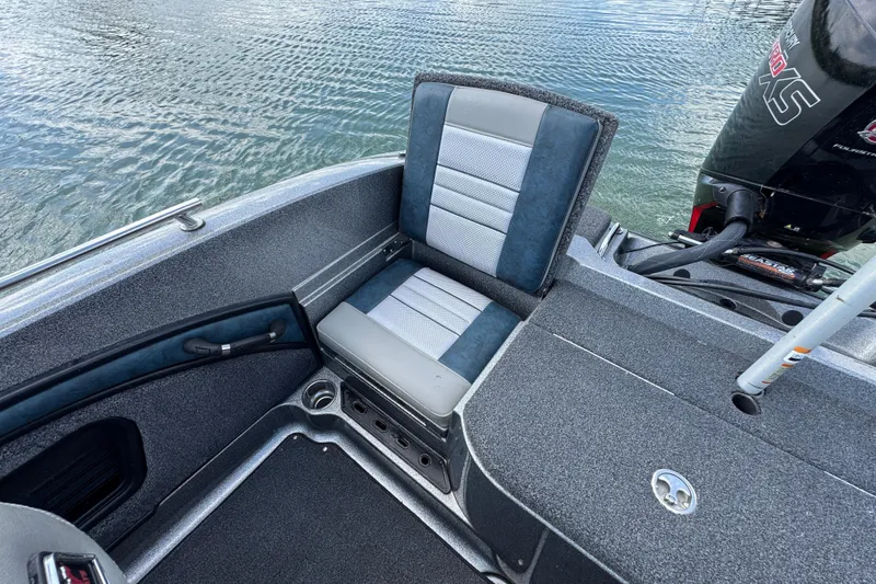 Slide: The Image of 2020 Ranger 2080MS Angler boat interior with cushioned seat and motor on water. - 21