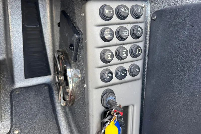 Slide: The Image of Control panel of a 2020 Ranger 2080MS Angler boat with various switches and keys. - 26