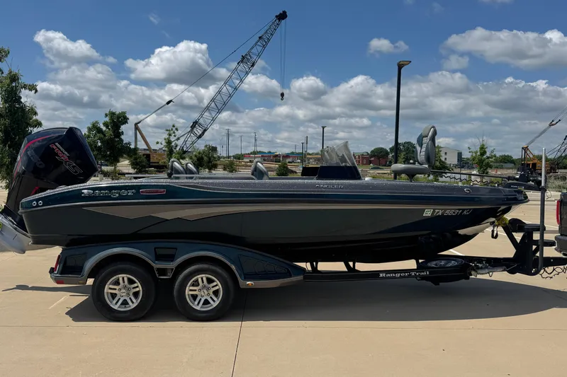 Slide: The Image of 2020 Ranger 2080MS Angler boat on trailer, parked outdoors under a blue sky. - 3