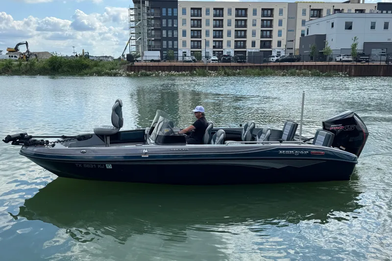 Slide: The Image of 2020 Ranger 2080MS Angler boat on water near urban buildings. - 6