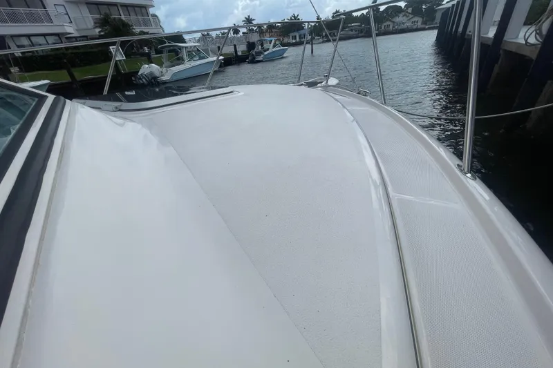 Slide: The Image of 2001 Tiara Yachts 2900 Coronet boat deck, docked near waterfront homes. - 14