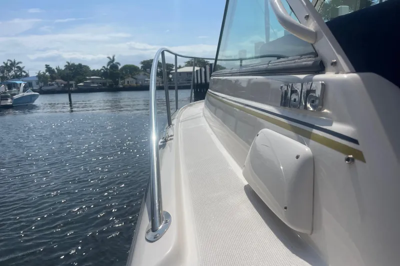 Slide: The Image of 2001 Tiara Yachts 2900 Coronet on calm water, showcasing sleek design and polished railing. - 18
