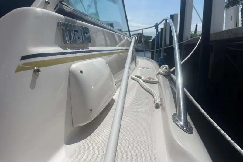 Slide: The Image of 2001 Tiara Yachts 2900 Coronet docked, showcasing sleek design and chrome railings. - 19