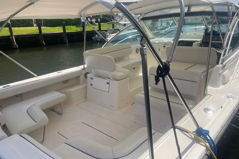 Slide: The Image of 2001 Tiara Yachts 2900 Coronet boat interior with white seating and canopy. - 20