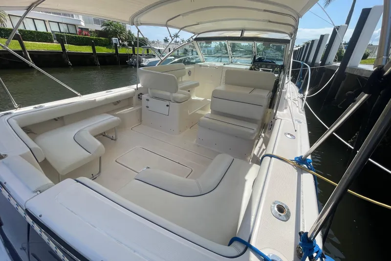 Slide: The Image of 2001 Tiara Yachts 2900 Coronet with spacious seating, docked by a canal. - 23