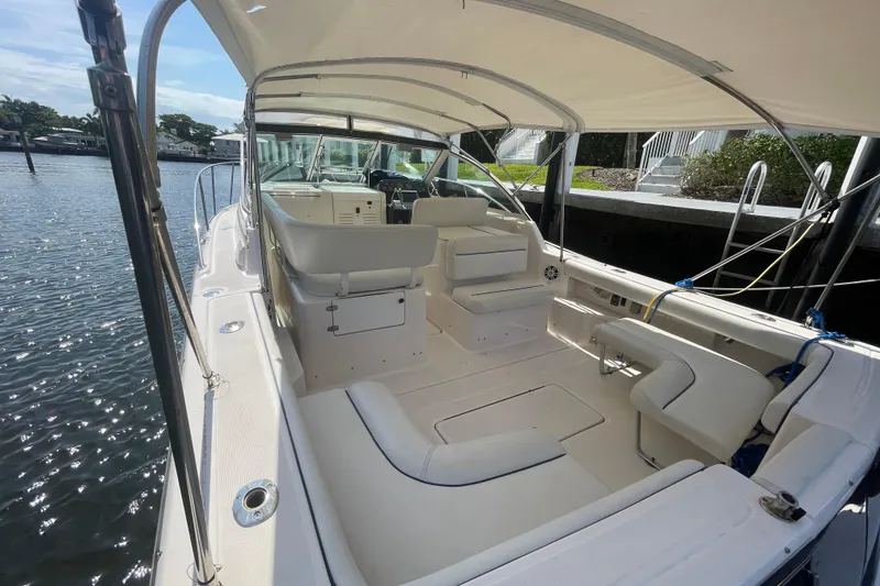Slide: The Image of 2001 Tiara Yachts 2900 Coronet boat interior with seating and canopy, docked by the water. - 24