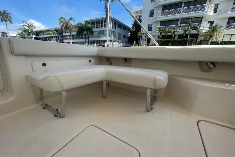 Slide: The Image of 2001 Tiara Yachts 2900 Coronet interior with white seating, docked near modern buildings. - 25