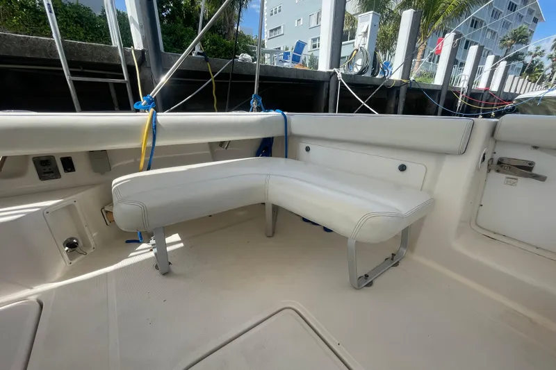 Slide: The Image of 2001 Tiara Yachts 2900 Coronet interior with white seating and dockside view. - 26
