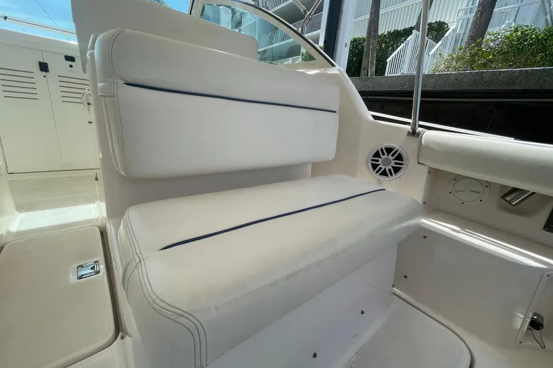 Slide: The Image of 2001 Tiara Yachts 2900 Coronet interior seating with white upholstery and speaker detail. - 27
