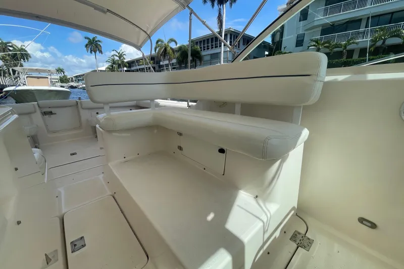 Slide: The Image of 2001 Tiara Yachts 2900 Coronet interior with white seating and sunny marina view. - 29