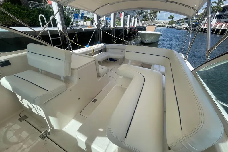 Slide: The Image of 2001 Tiara Yachts 2900 Coronet interior with white seating, docked by the water. - 33