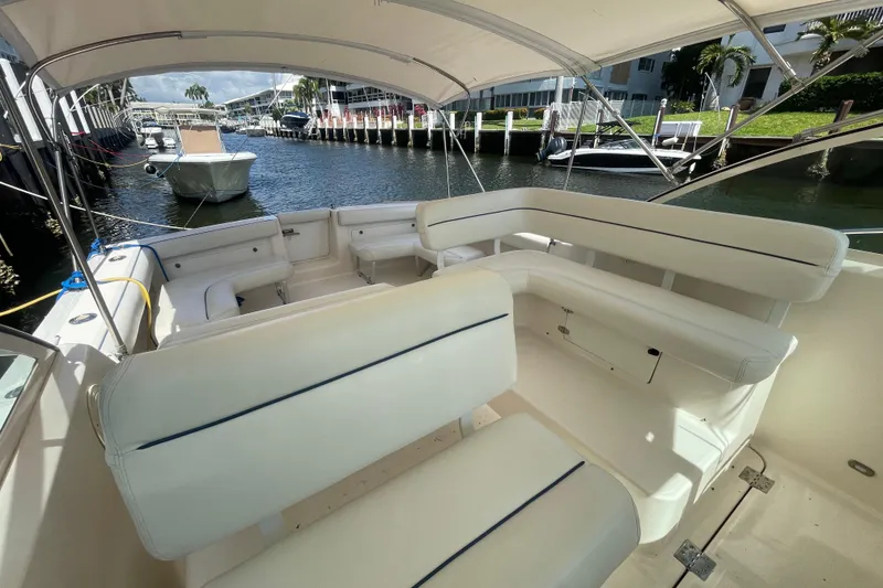 Slide: The Image of 2001 Tiara Yachts 2900 Coronet interior with white seating, docked in a sunny marina. - 34