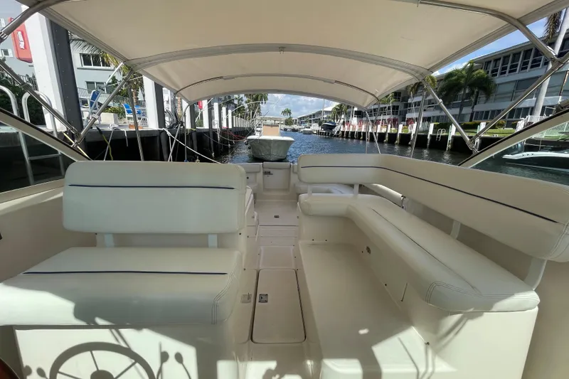 Slide: The Image of 2001 Tiara Yachts 2900 Coronet interior with spacious seating and canopy, docked by waterfront. - 35
