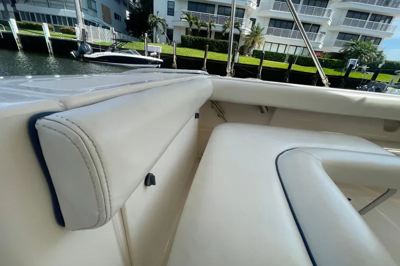 Slide: The Image of 2001 Tiara Yachts 2900 Coronet interior with white leather seating, docked near waterfront buildings. - 37