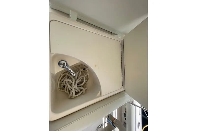 Slide: The Image of Storage compartment with coiled rope on a 2001 Tiara Yachts 2900 Coronet. - 39