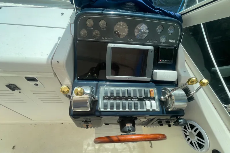 Slide: The Image of Helm of 2001 Tiara Yachts 2900 Coronet with gauges, controls, and navigation equipment. - 42