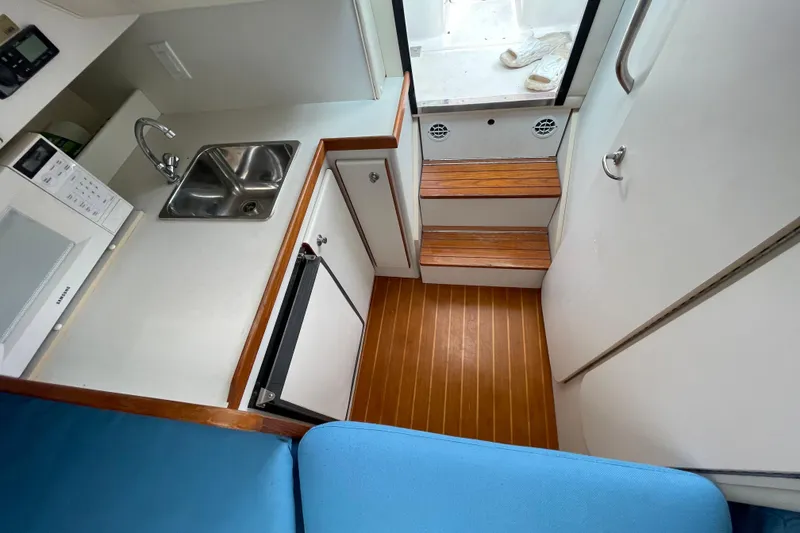 Slide: The Image of Interior of 2001 Tiara Yachts 2900 Coronet with kitchenette and wooden flooring. - 45