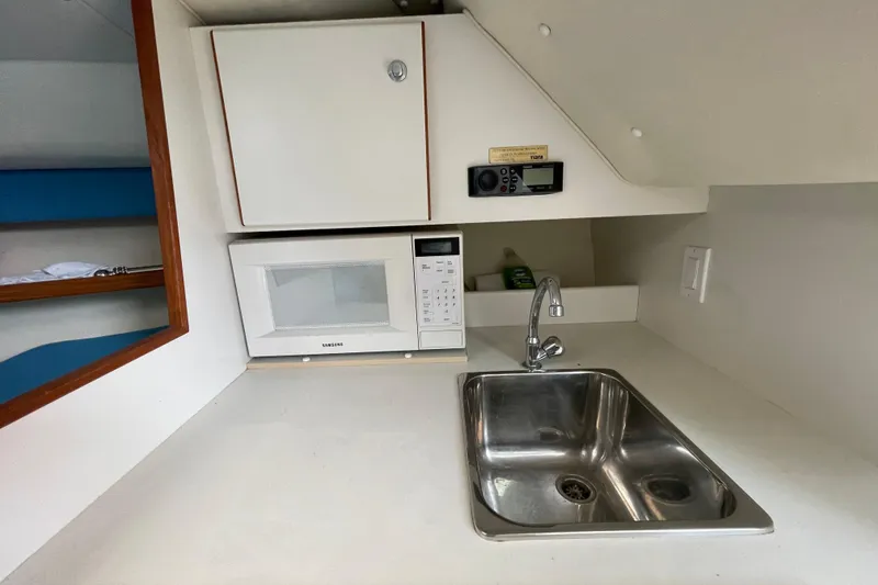 Slide: The Image of Compact kitchen area in a 2001 Tiara Yachts 2900 Coronet with sink and microwave. - 48