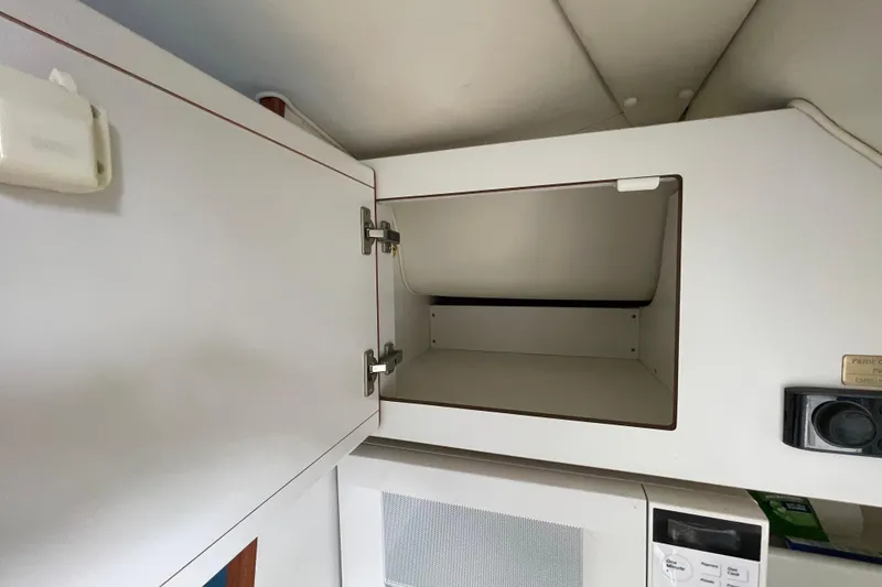 Slide: The Image of Open cabinet in 2001 Tiara Yachts 2900 Coronet interior, above microwave. - 52