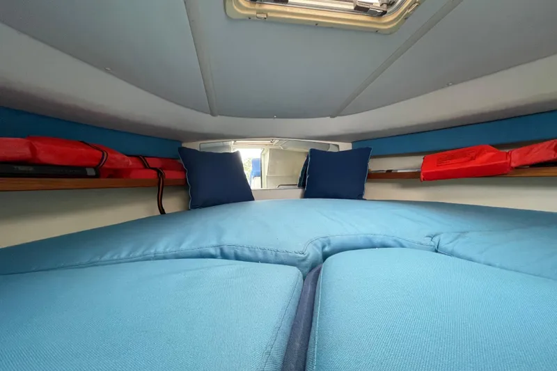 Slide: The Image of Interior cabin of 2001 Tiara Yachts 2900 Coronet with blue cushions and life jackets. - 56