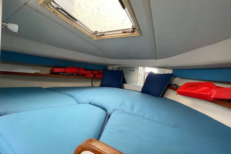 Slide: The Image of Interior cabin of 2001 Tiara Yachts 2900 Coronet with blue cushions and life jackets. - 57