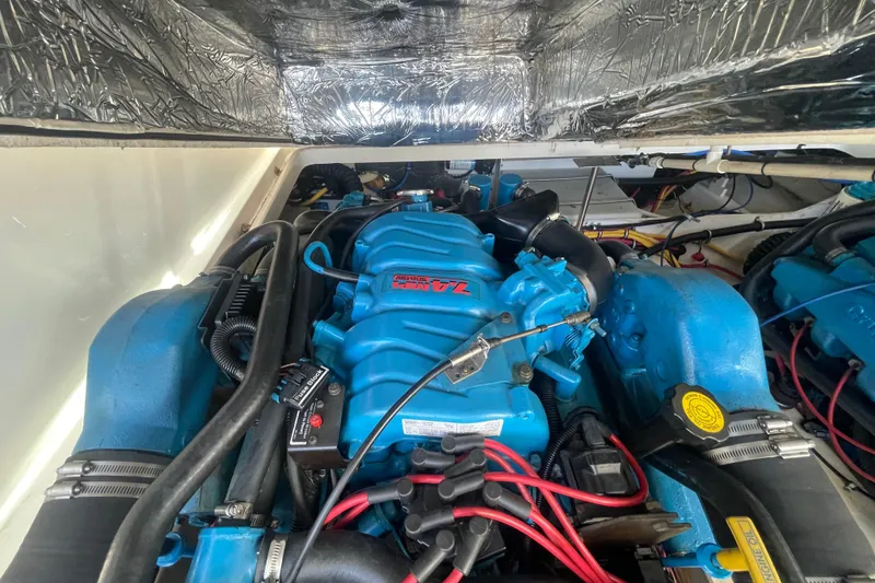 Slide: The Image of Engine compartment of a 2001 Tiara Yachts 2900 Coronet, featuring a blue marine engine. - 59