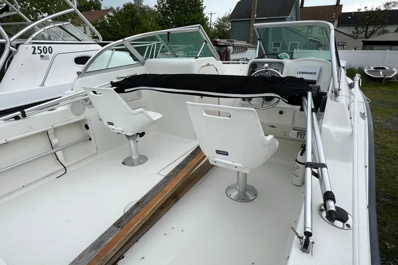 Slide: The Image of 2004 Hydra-Sports Lightning 202 DC boat interior with seating and steering console. - 4
