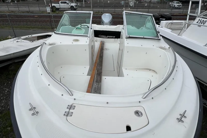 Slide: The Image of 2004 Hydra-Sports Lightning 202 DC boat with open bow seating and windshield, docked outdoors. - 6