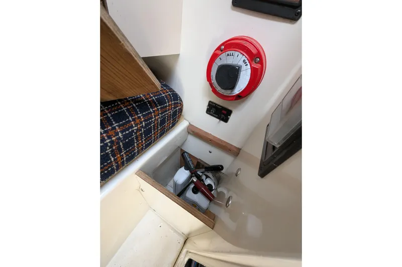 Slide: The Image of Interior of 1982 Pearson 323 sailboat showing battery switch and plaid upholstery. - 12