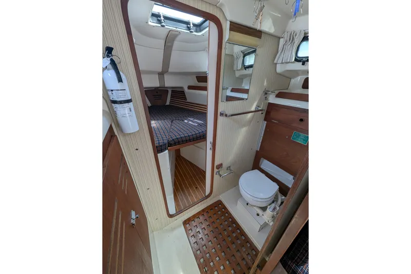 Slide: The Image of Interior of 1982 Pearson 323 sailboat featuring cabin and bathroom amenities. - 18