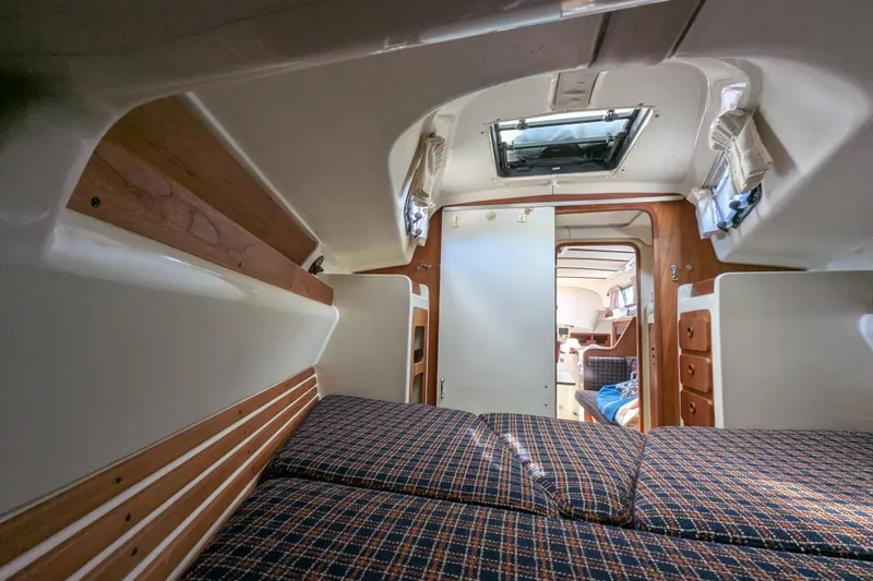 Slide: The Image of Interior of a 1982 Pearson 323 sailboat, featuring a cozy cabin with wood accents. - 24