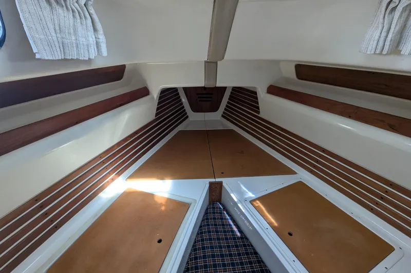Slide: The Image of Interior of 1982 Pearson 323 sailboat with wooden accents and striped cushions. - 25